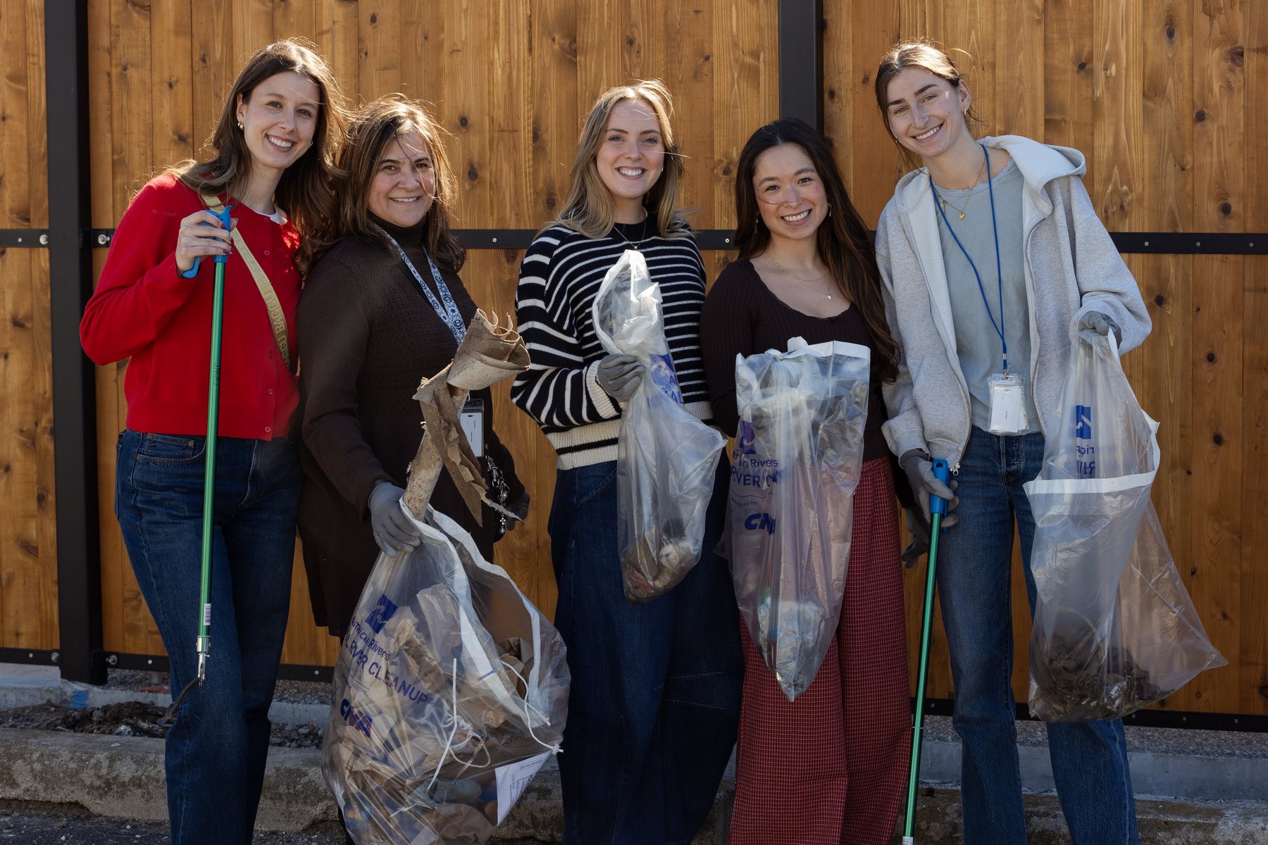 Participants holding collected materials during the Detroit Green Salon Impact Tour activity